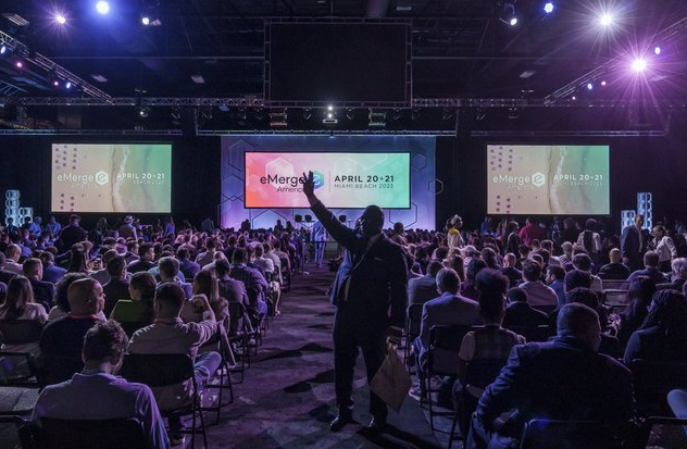 Attendees at eMerge Americas conference participating in a Miami Business networking event focused on tech and innovation.